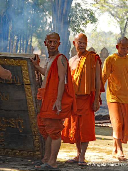 monks standing by a sign
