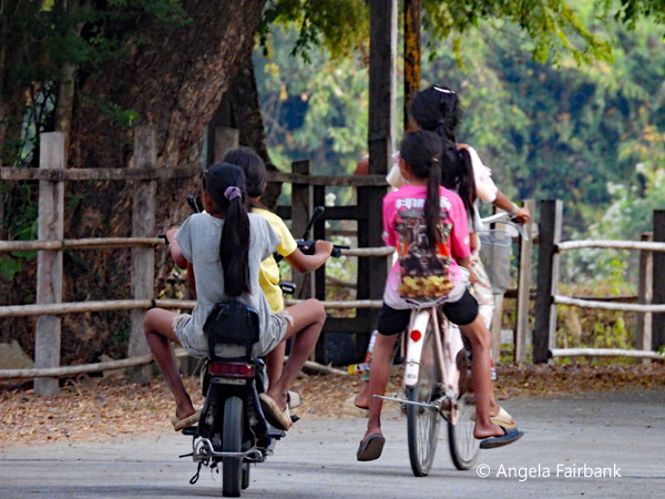 girls on bikes on khone island