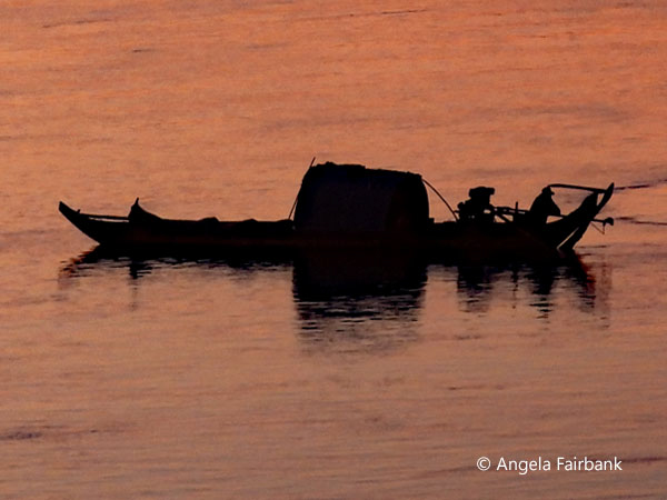 silhouette of boat at sunset on the Mekong 1