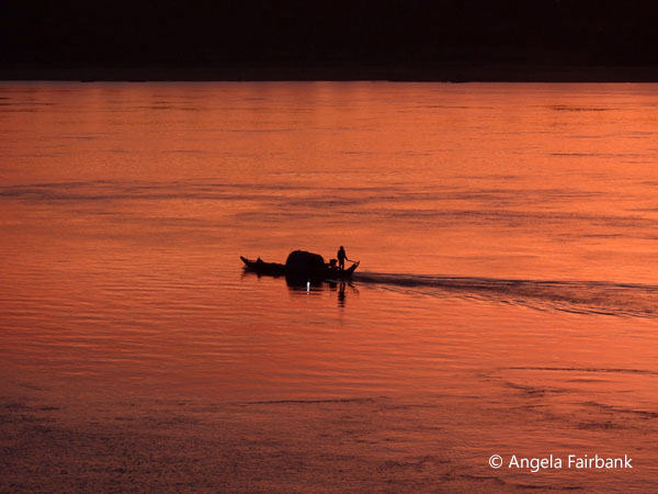 silhouette of boat at sunset on the Mekong 2