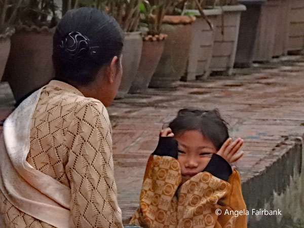 mother and daughter waiting for the monks and novices to arrive