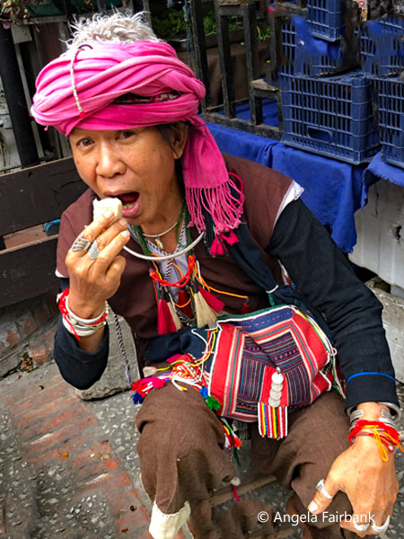 hilltribe man eating at morning market