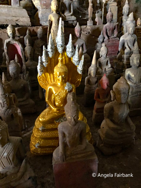 many buddha statues in Pak Ou Caves