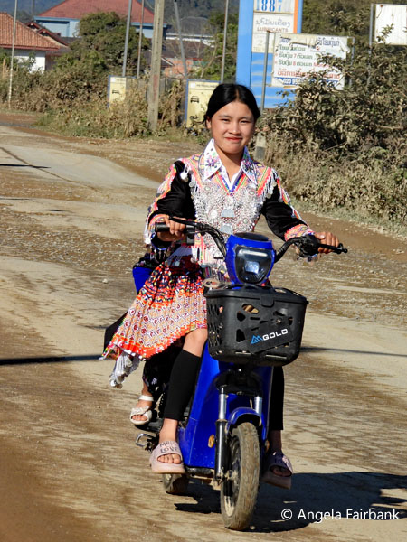 hill tribe woman and child on scooter