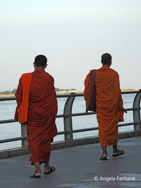 2 monks walking by the river