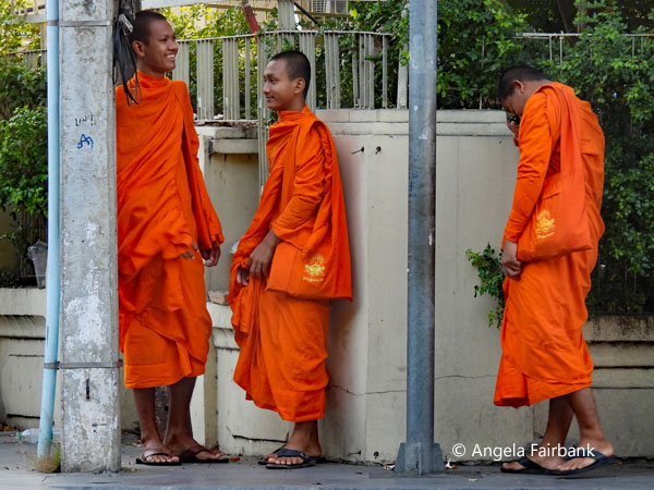 3 novice monks waiting to cross the street