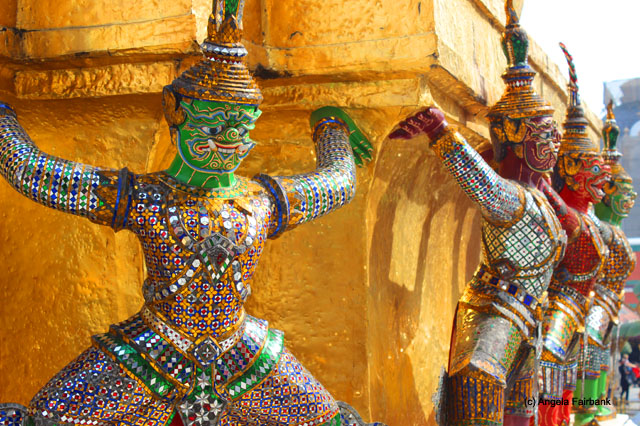 four statues holding up wall at Wat Phra Kaeo temple complex