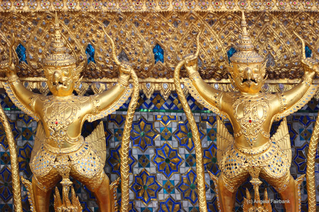 guilded images with snakes at Wat Phra Kaeo temple complex