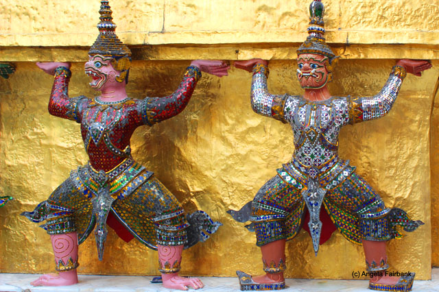 statues holding up wall of building at Wat Phra Kaeo temple complex