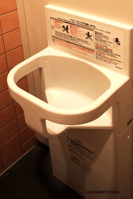 baby seat in toilet cubicle