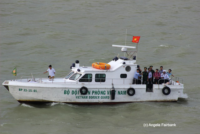 Vietnamese officials coming to the ship via boat