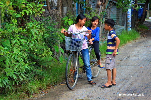 children chatting and a bicycle