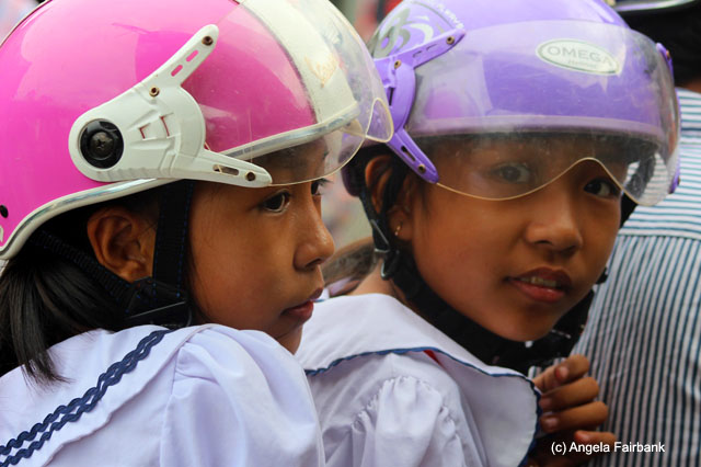 girls on the back of a scooter
