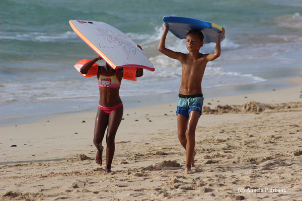kids with surf boards at kite sailing beach