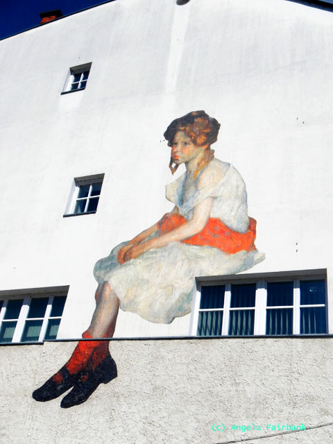 painting of girl on side of house