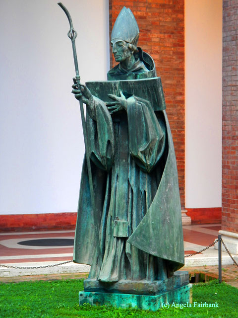 statue outside church on hill