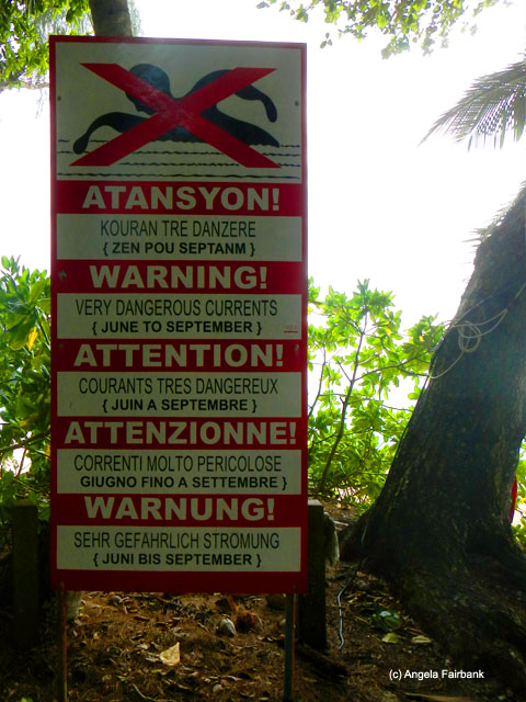 beach warning sign in five languages including creole, Intendance beach, Seychelles