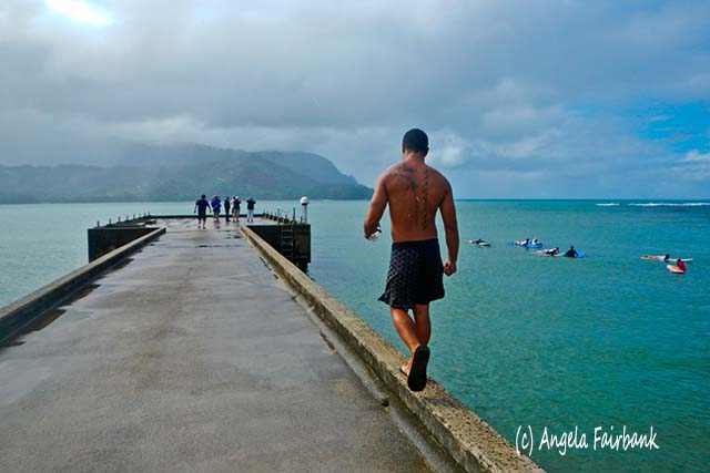 Surfer on wharf, Hanalei Bay, Kauai, Hawaii, copyright Angela Fairbank