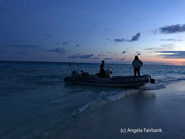 dinghy against sunset