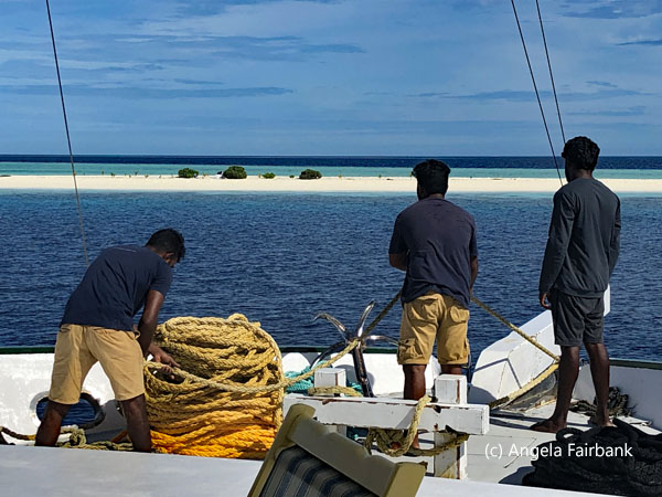 3 crew pulling up the anchor