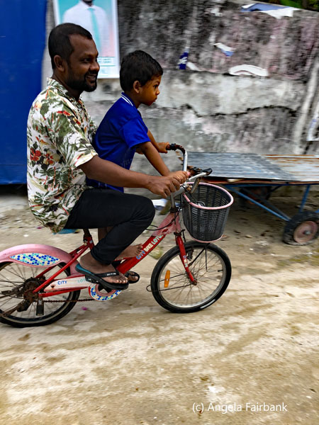 man and boy on bike