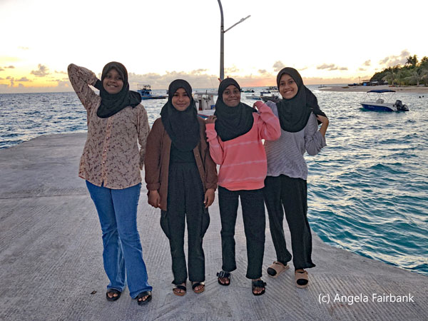 four female teenagers poising