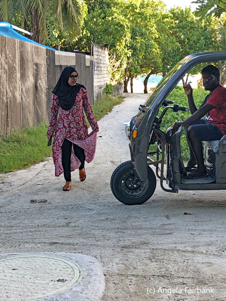 woman and tuk tuk driver