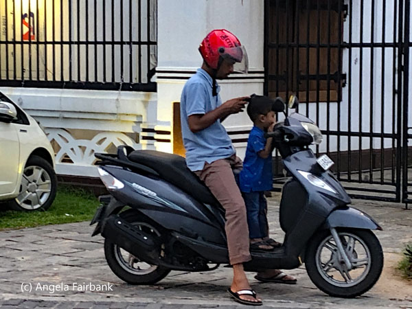 man and boy on motorbike