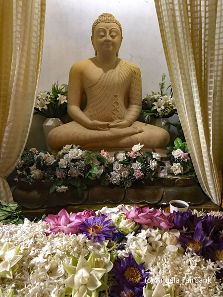 buddha statue with flowers