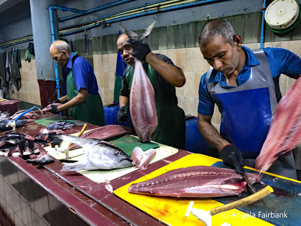 men fileting fish