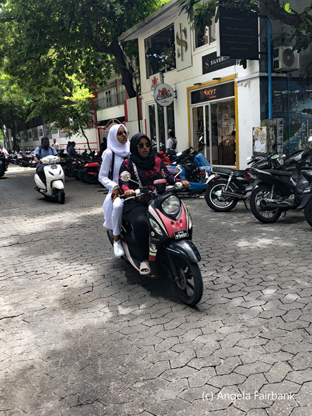 2 women on scooter