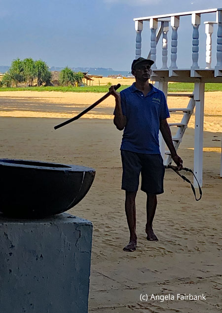 man with slingshot and stick