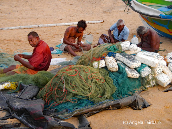 men repairing nets