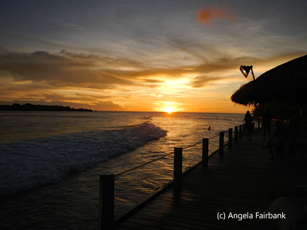 sunset with building and surf