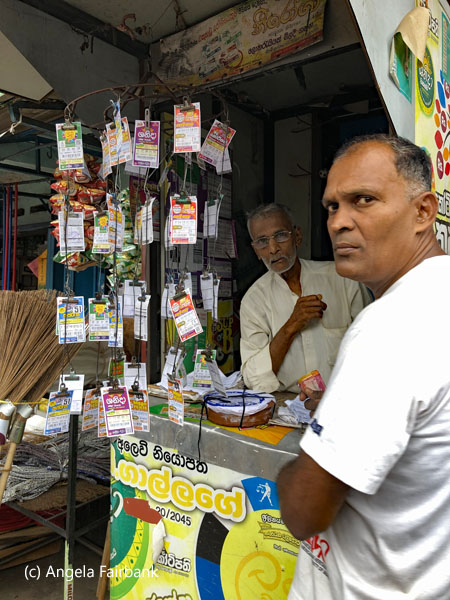 men at lottery ticket booth