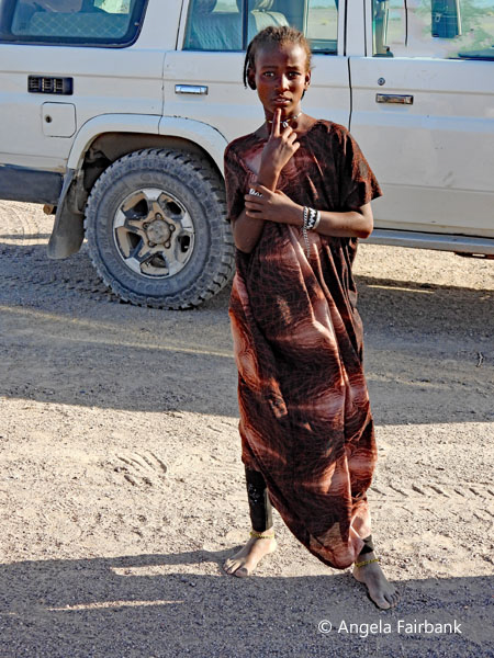 Afar girl in front of our vehicle