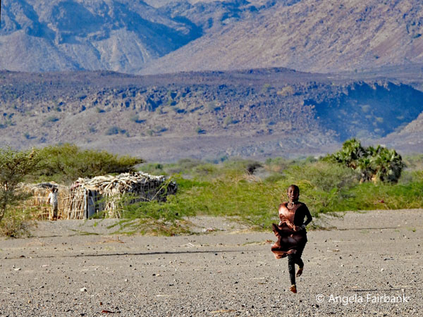 Afar child running towards us