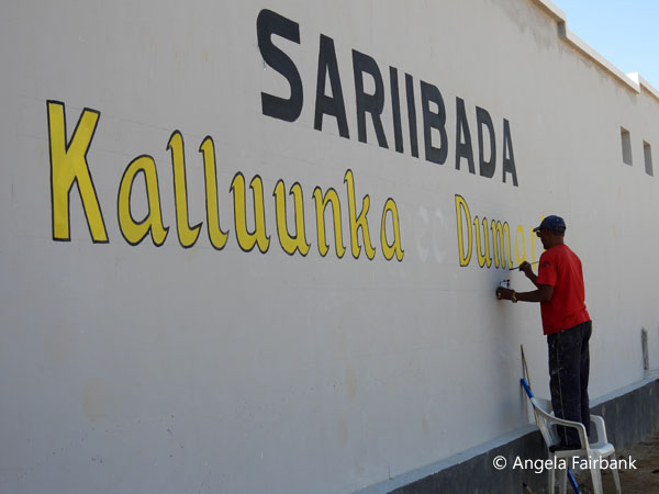 sign on fish market being painted 2