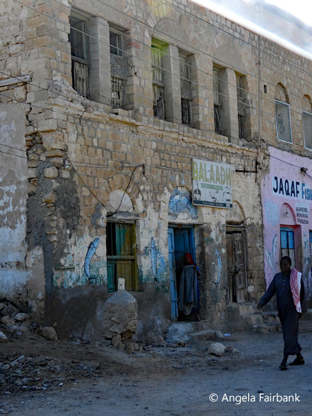 man in front of buildings in Darole