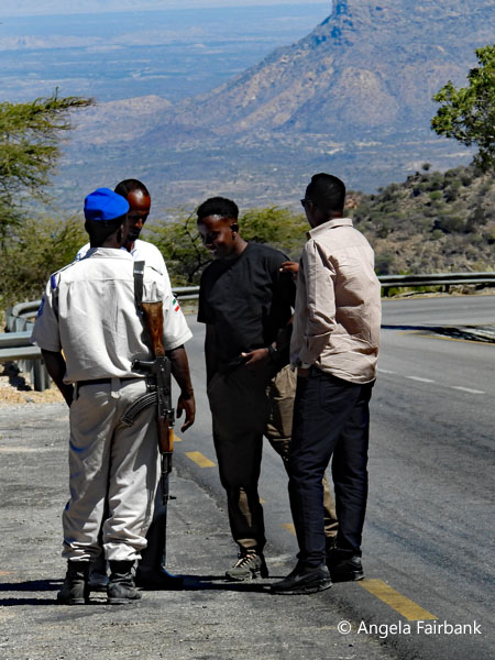 drivers and guards at a stop in the mountains
