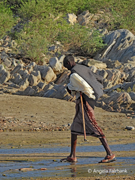 man walking in riverbed 2
