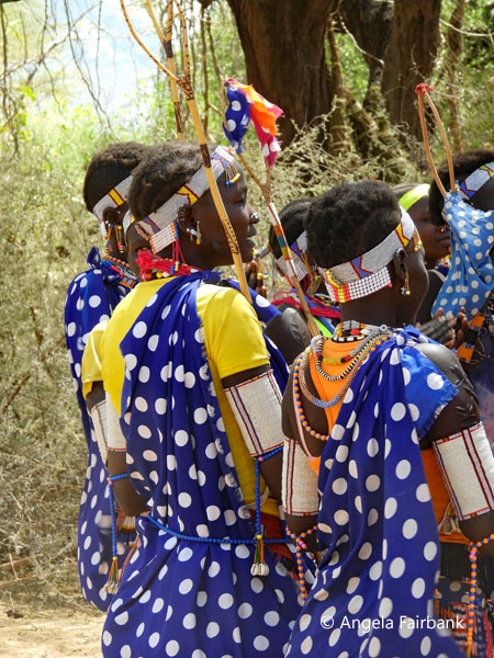 grou pof Boya women in blue with white polka dotted coverings