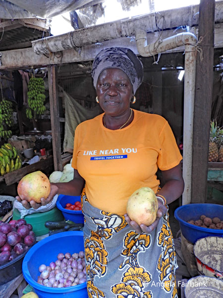 fruit and vegetable market vendor with mangos