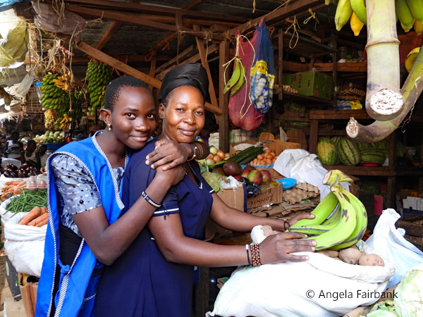 mother and daughter at fruit and vegetable market