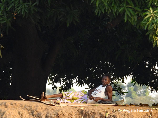 youth relaxing on river bank