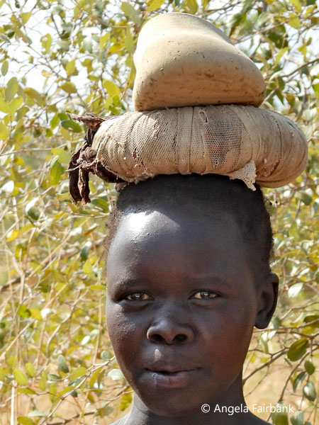 Kuku woman carrying load on head