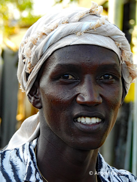 Toposa youth in white turban at market