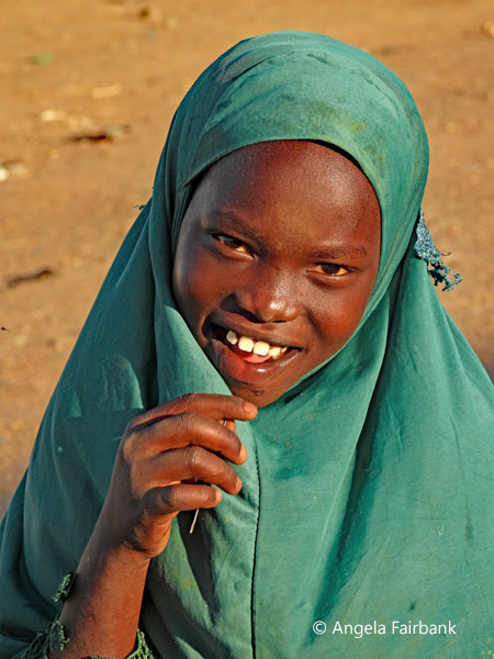 Muslim girl in green at market