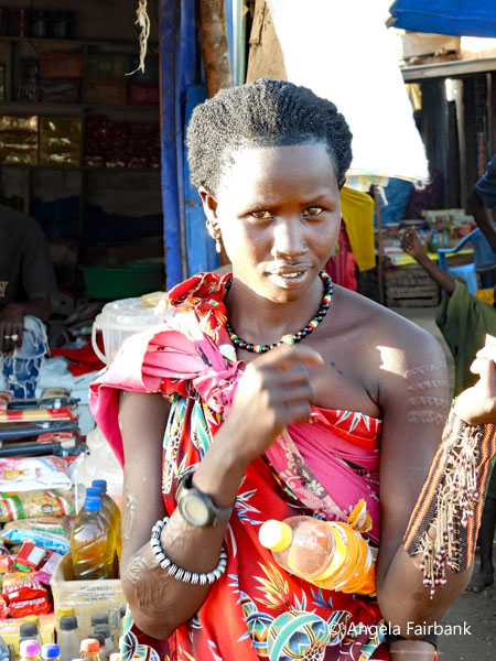 woman with fancy bracelets in market