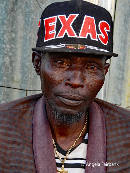Older man in Texas baseball cap at market